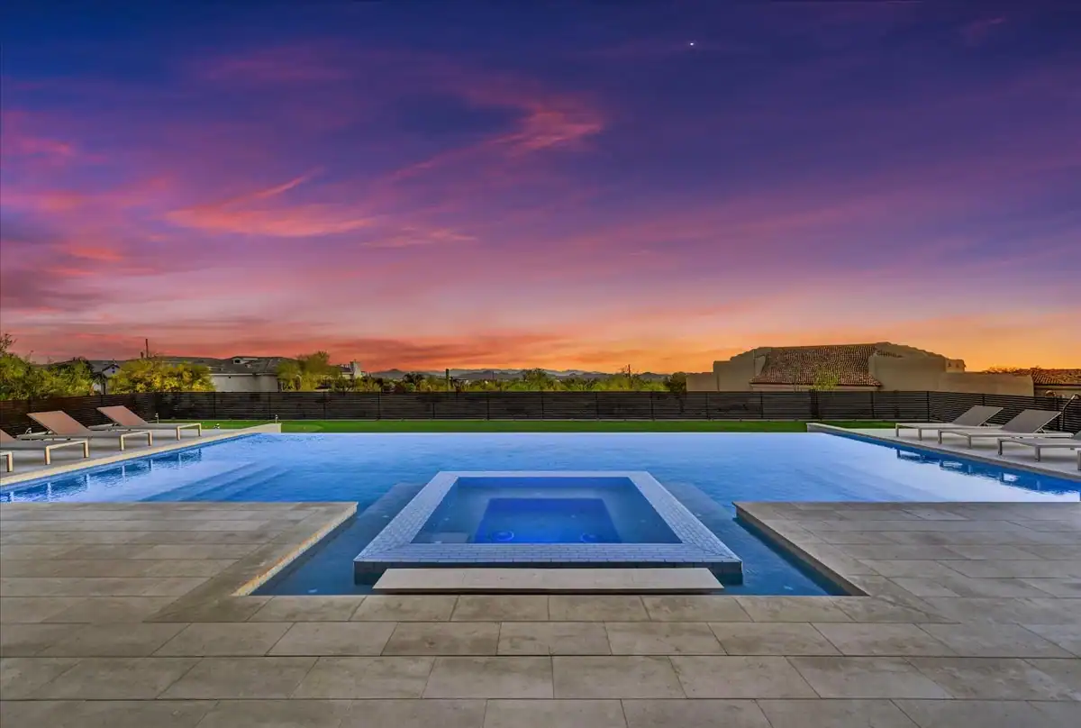 Twilight view of a custom pool, spa, and landscape design by DBCH
